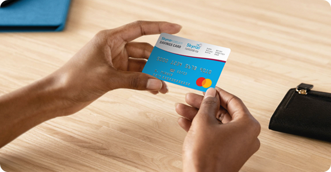 Hand holding a Skyrizi Complete Savings Card