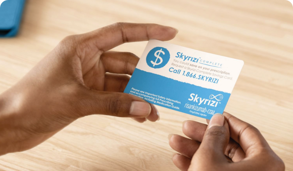 Hand holding a Skyrizi Complete Savings Card