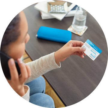 A Person Woman holding Skyrizi Complete Savings Card